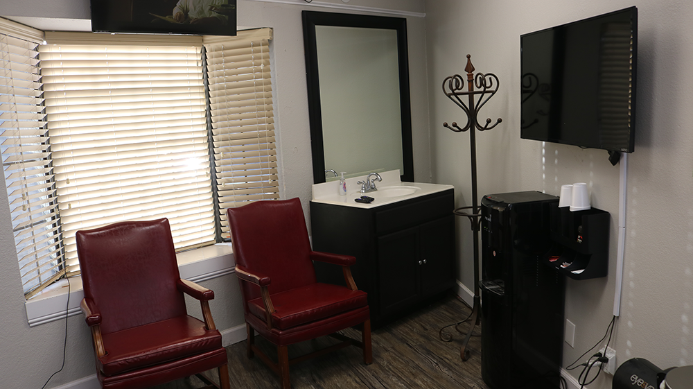 Waiting area and sink at Bladez Barber Fort Worth barber chair share